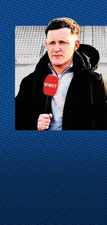 Seán O'Regan, a reporter, holds a microphone and looks off campus