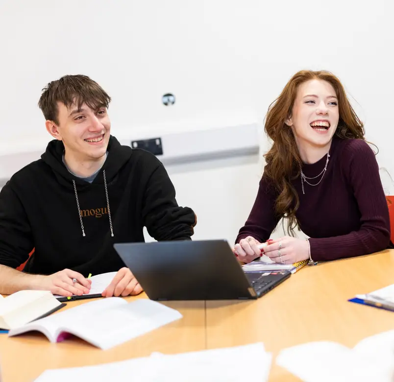 Students working on a laptop together