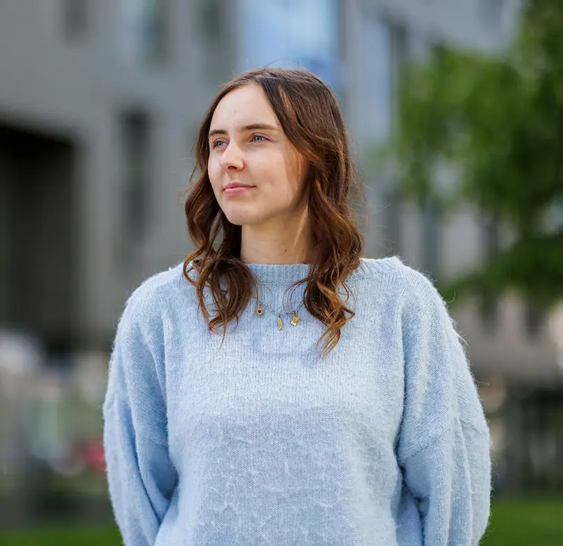 A student looks off to the right of the image