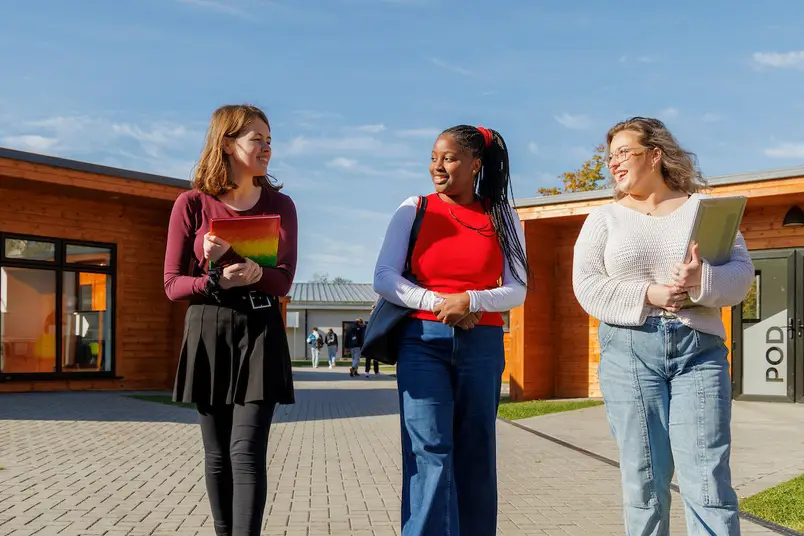 3 students walk away from our North Campus study pods