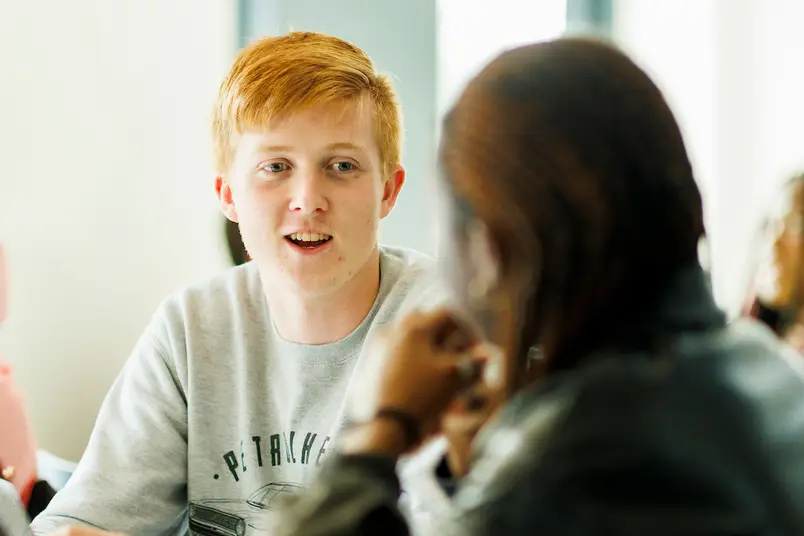A student talking in a classroom
