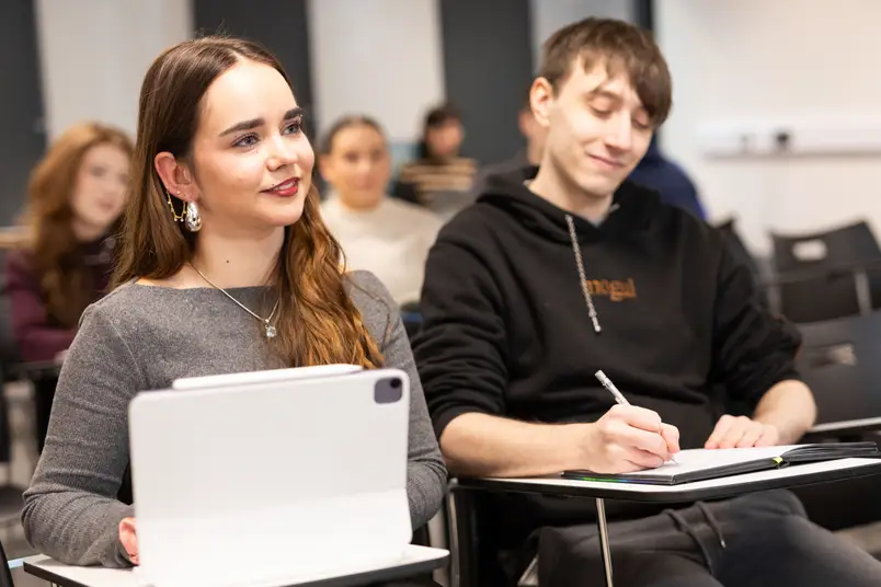 Two students sit in a classroom