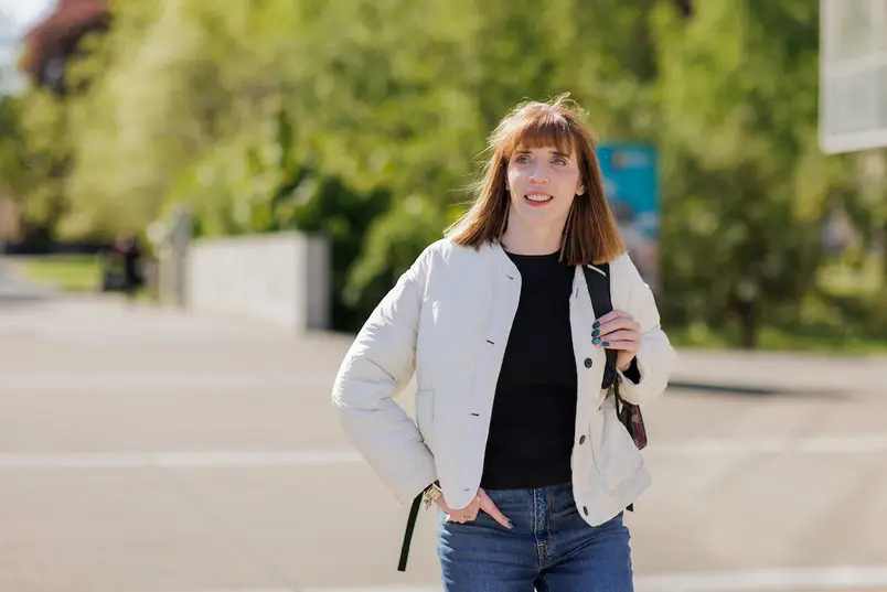 A student walking past the library from South campus